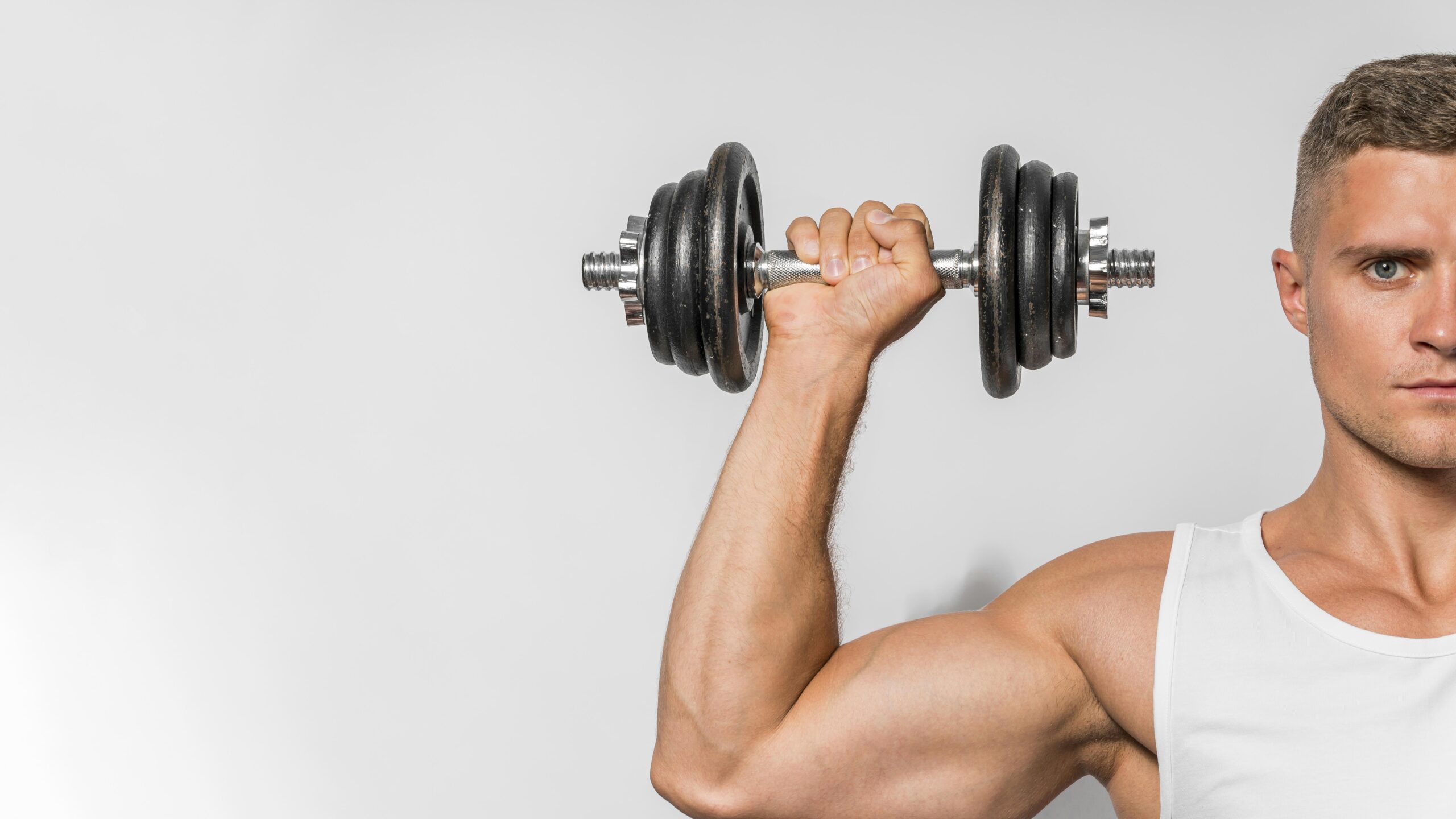 front-view-fit-man-with-tank-top-holding-up-weights-with-copy-space